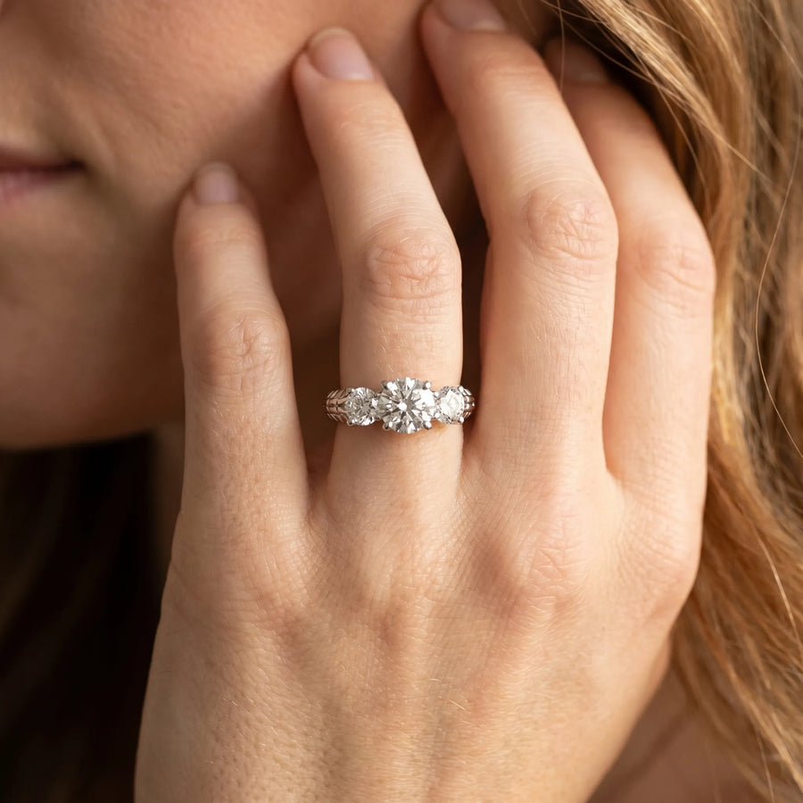 White gold Three-Stone Round Cut Diamond Ring with Channel-Set Band and Prong Setting