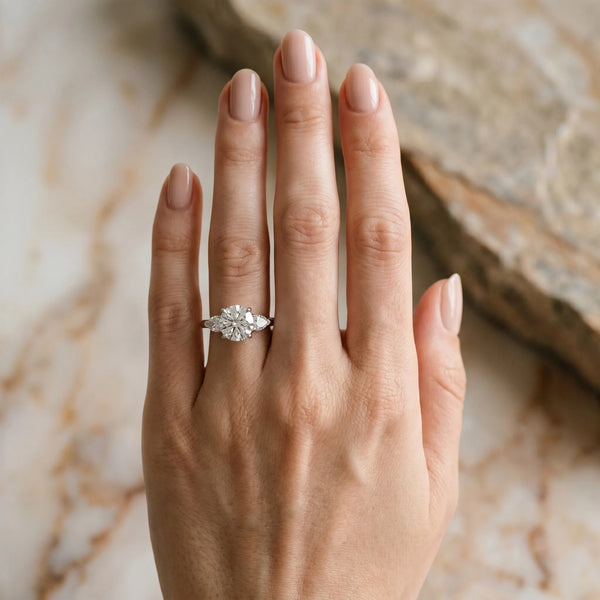 White gold Three-Stone Round Cut Diamond Ring with Pear Side Stones and Four-Prong Setting