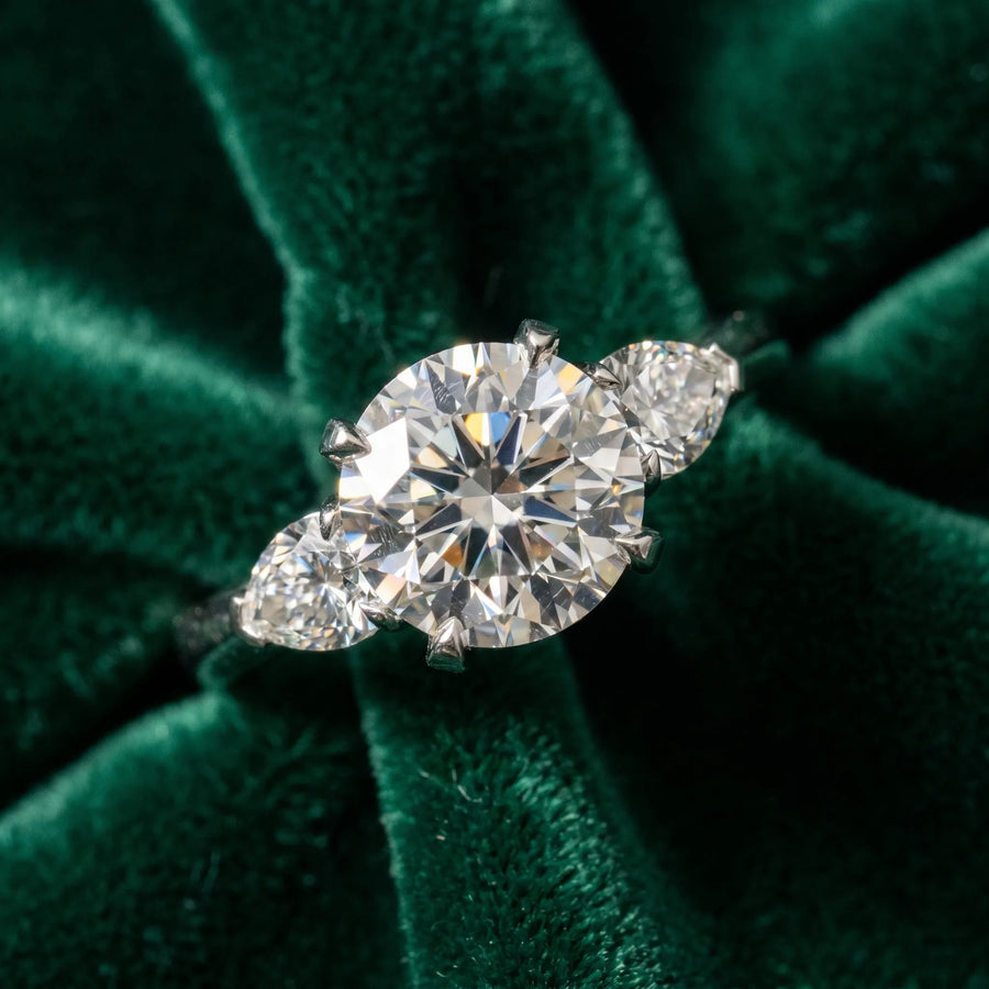 White gold Three-Stone Round Cut Diamond Ring with Pear Side Stones and Four-Prong Setting