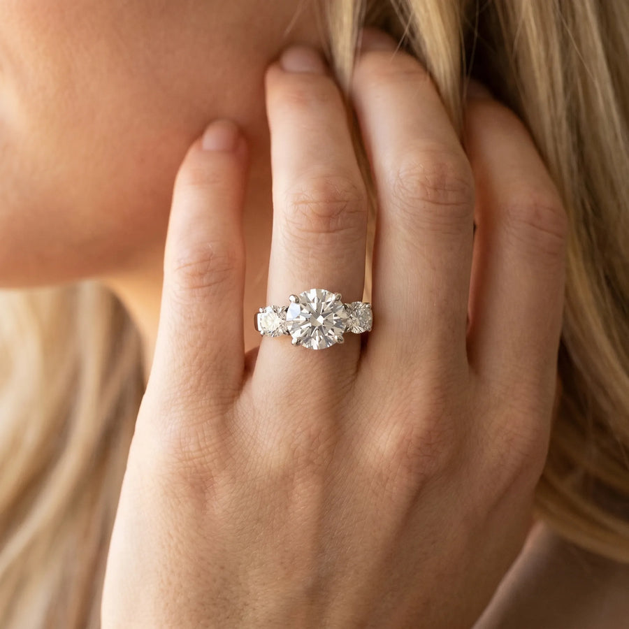 White gold Three-Stone Round Cut Diamond Ring with Round Accent Stones, Prong Setting, and Classic Band