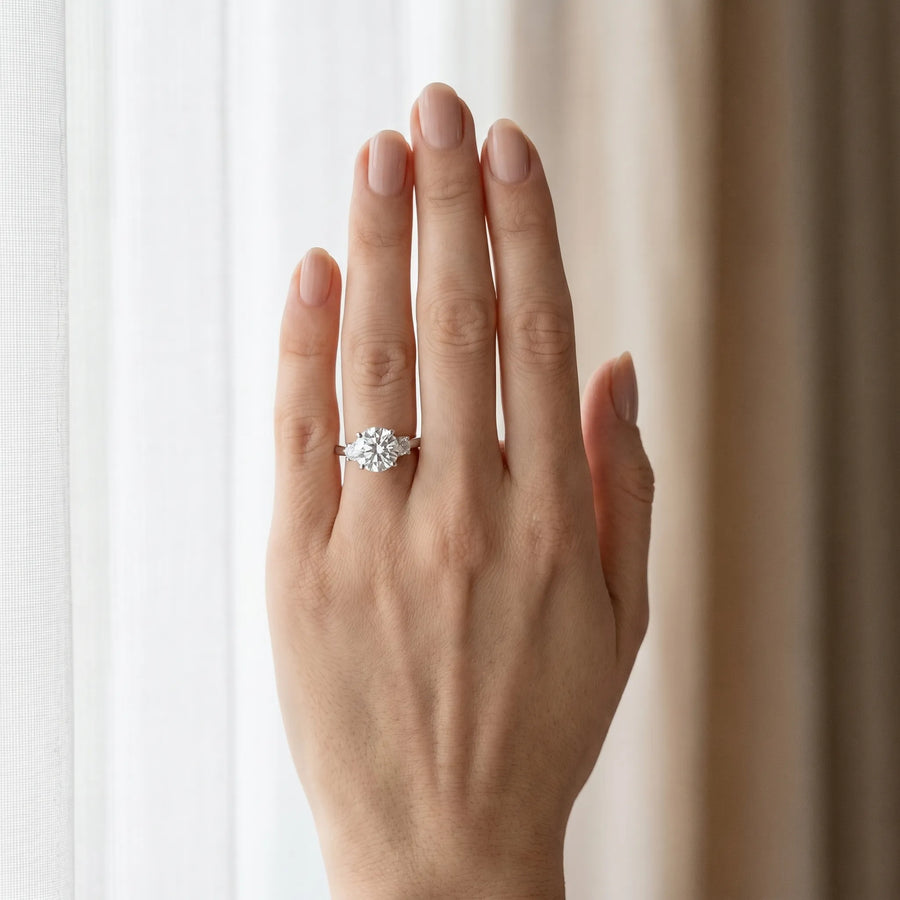 White gold Three-Stone Round Cut Diamond Solitaire with Prong Setting and Classic Band