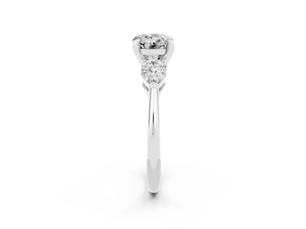 Platinum Three-Stone Round Cut Moissanite Ring with Pear Side Stones and Four-Prong Setting