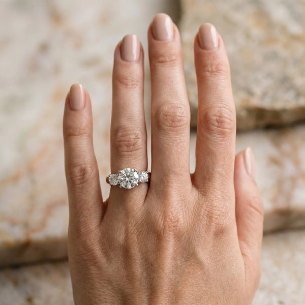 White gold Three-Stone Round Cut Solitaire Ring with Cathedral Band and Four-Prong Setting
