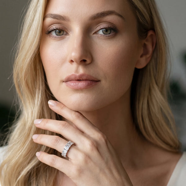 Platinum emerald cut diamond half eternity band with shared prong setting