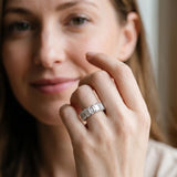 White gold emerald cut diamond half eternity band with shared prong setting_36
