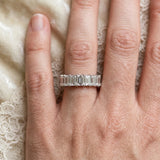 White gold emerald cut diamond half eternity band with shared prong setting_37