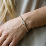 Yellow gold Bezel-Set Round Diamond Tennis Bracelet with Radiant Center Diamond