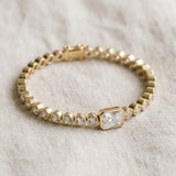 Yellow gold Bezel-Set Round Diamond Tennis Bracelet with Radiant Center Diamond