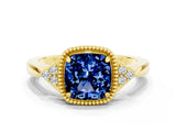 Yellow gold Cushion Cut Blue Sapphire Halo Ring with Tapered Band and Four-Prong Setting