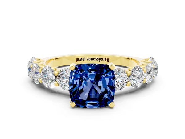 Yellow gold Cushion Cut Blue Sapphire Prong Setting with Side Stones on a Pave Band