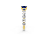 Yellow gold Cushion Cut Blue Sapphire Prong Setting with Side Stones on a Pave Band_2