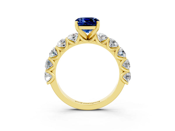 Yellow gold Cushion Cut Blue Sapphire Prong Setting with Side Stones on a Pave Band