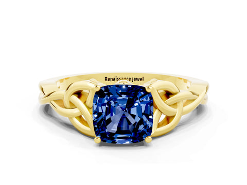Yellow gold Cushion Cut Blue Sapphire Solitaire Engagement Ring with Celtic Knot Band and Four-Prong Setting