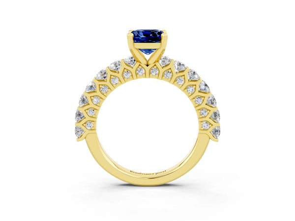 Yellow gold Cushion Cut Blue Sapphire Solitaire Ring with Shared Prong Pavé Band and Four-Prong Setting