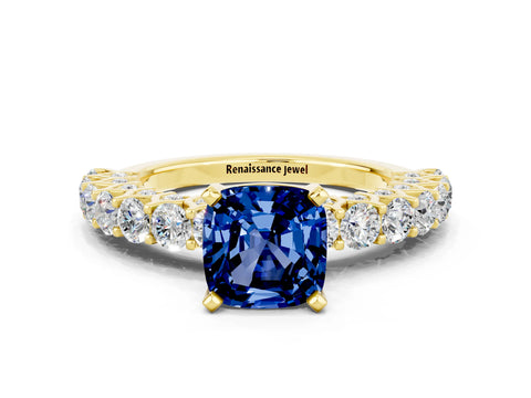 Yellow gold Cushion Cut Blue Sapphire Solitaire Ring with Shared Prong Pavé Band and Four-Prong Setting