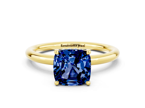 Yellow gold Cushion Cut Blue Sapphire Solitaire Ring with Thin Band and Four-Prong Setting