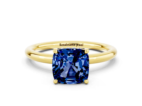 Yellow gold Cushion Cut Blue Sapphire Solitaire Ring with Thin Band and Four-Prong Setting