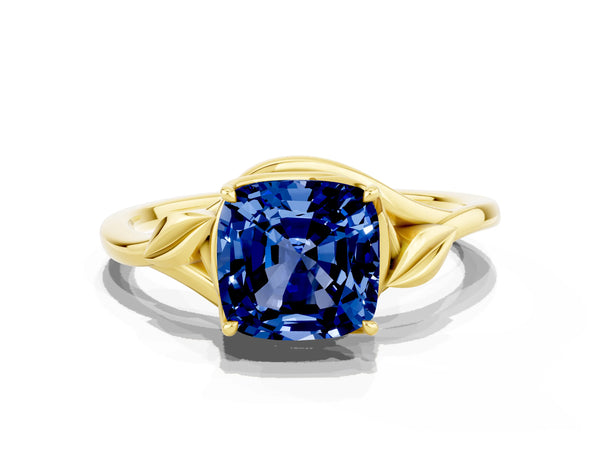 Yellow gold Cushion Cut Blue Sapphire Solitaire Ring with Twist Band and Four-Prong Setting