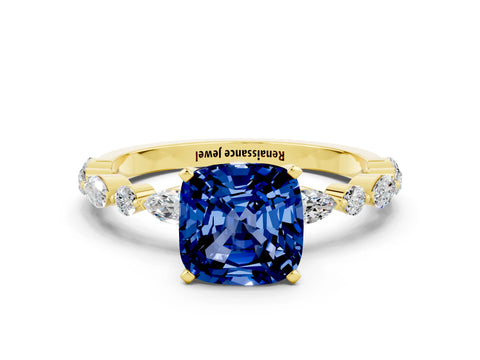 Yellow gold Cushion Cut Blue Sapphire Solitaire with Side Stones on a Pavé Band and Four-Prong Setting