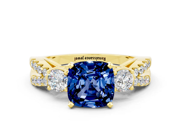 Yellow gold Cushion Cut Blue Sapphire Three-Stone Ring with Pavé Split Shank and Four-Prong Setting