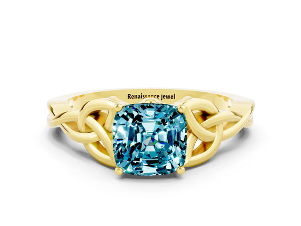 Yellow gold Cushion Cut Blue Topaz Solitaire Engagement Ring with Celtic Knot Band and Four-Prong Setting