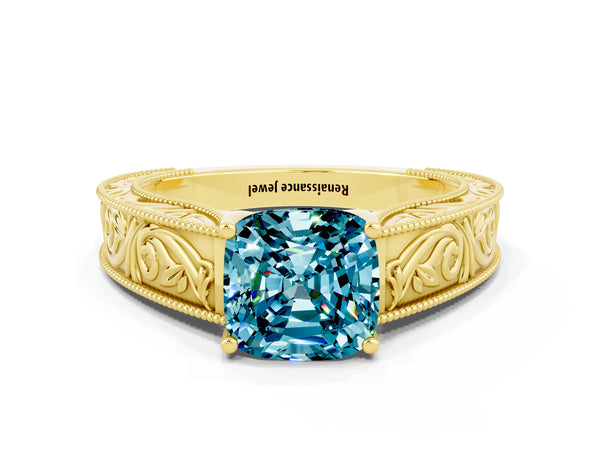 Yellow gold Cushion Cut Blue Topaz Solitaire Ring with Engraved Band and Four-Prong Setting