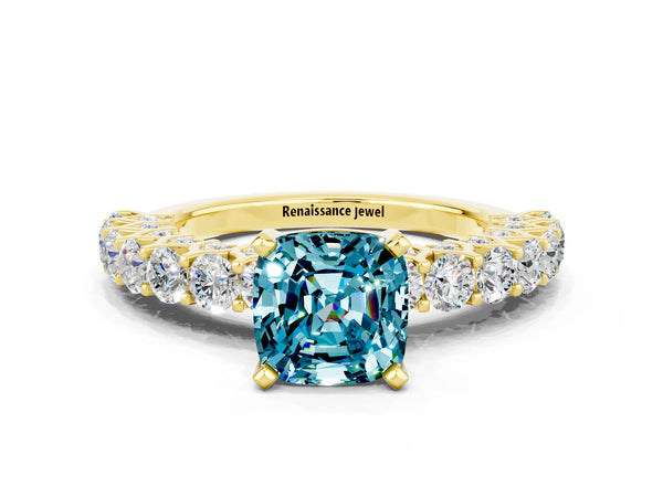 Yellow gold Cushion Cut Blue Topaz Solitaire Ring with Shared Prong Pavé Band and Four-Prong Setting