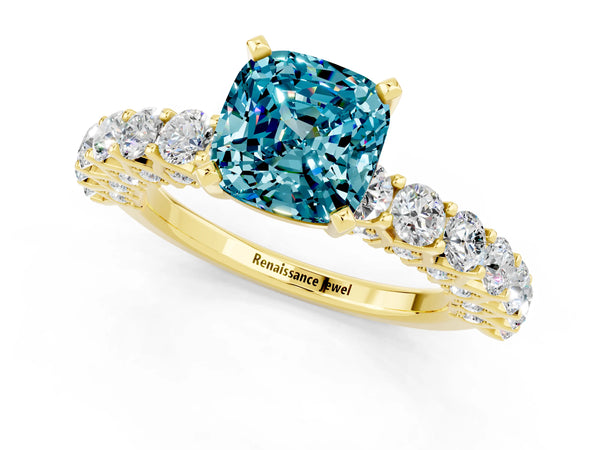 Yellow gold Cushion Cut Blue Topaz Solitaire Ring with Shared Prong Pavé Band and Four-Prong Setting