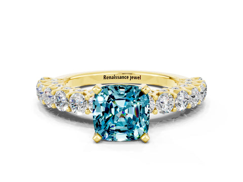 Yellow gold Cushion Cut Blue Topaz Solitaire Ring with Shared Prong Pavé Band and Four-Prong Setting