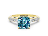 Yellow gold Cushion Cut Blue Topaz Solitaire with Side Baguettes and Channel Set Band