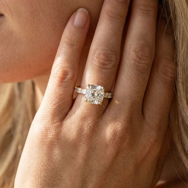 Yellow gold Cushion Cut Diamond Solitaire with Side Baguettes and Channel Set Band