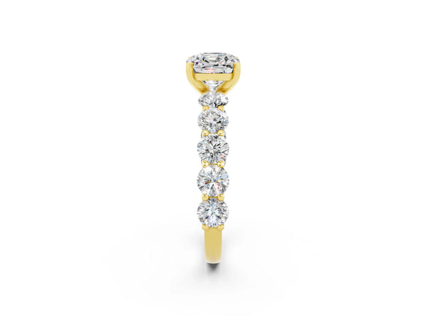 Yellow gold Cushion Cut Moissanite Prong Setting with Side Stones on a Pave Band