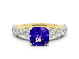 Yellow gold Cushion Cut Tanzanite Prong Setting with Side Stones on a Pave Band