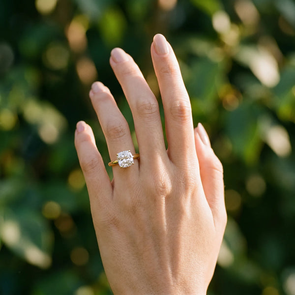 Yellow gold Cushion Solitaire Diamond Engagement Ring with Four-Prong Setting on a Classic Band