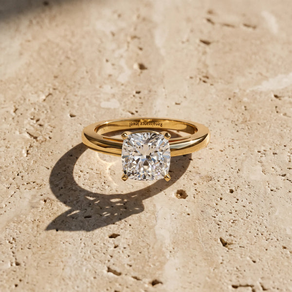 Yellow gold Cushion Solitaire Diamond Engagement Ring with Four-Prong Setting on a Classic Band