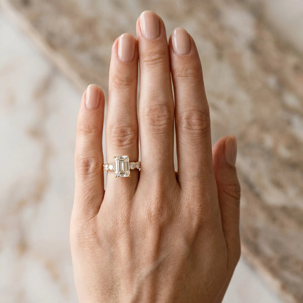 Yellow gold Emerald Brilliant Diamond Five-Stone Engagement Ring with Prong Setting on a Classic Band