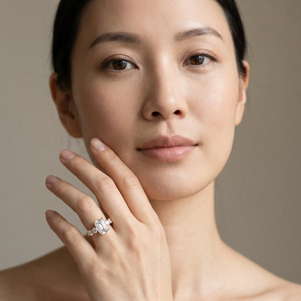 Yellow gold Emerald Brilliant Diamond Five-Stone Engagement Ring with Prong Setting on a Classic Band