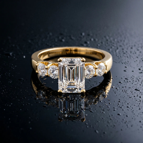Yellow gold Emerald Brilliant Diamond Five-Stone Engagement Ring with Prong Setting on a Classic Band