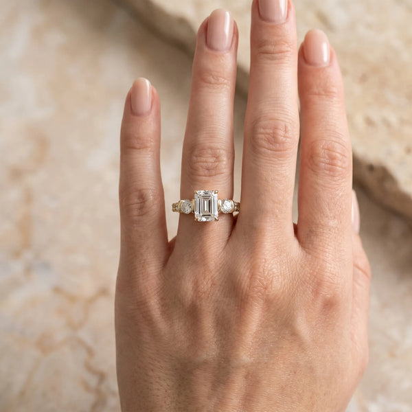 Yellow gold Emerald Brilliant Trilogy Channel Set Diamond Ring with Bar Prongs