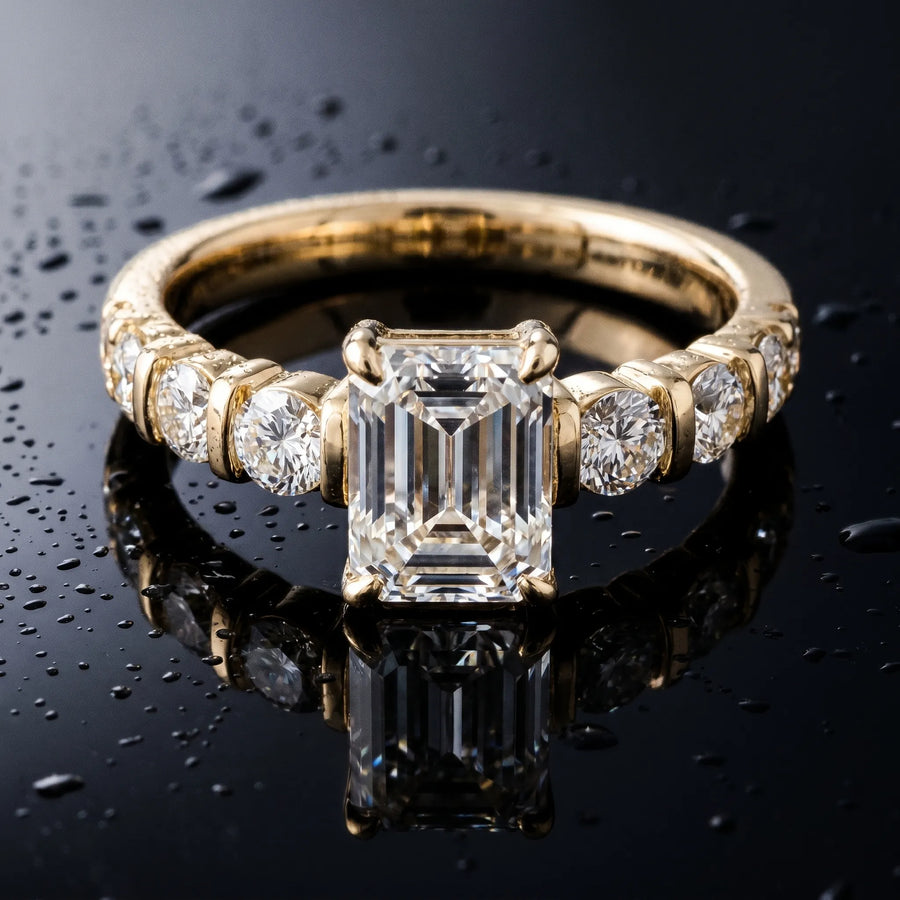 Yellow gold Emerald Brilliant Trilogy Channel Set Diamond Ring with Bar Prongs