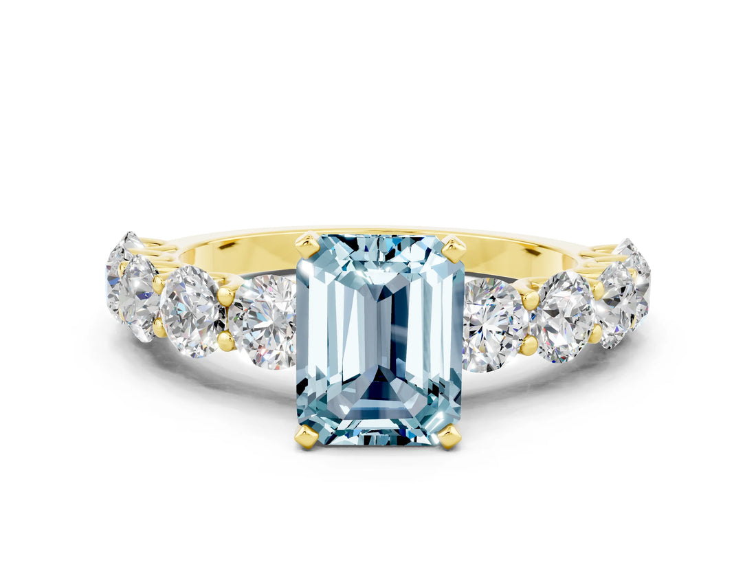 Yellow gold Emerald Cut Aquamarine Prong Setting with Side Stones on a Pave Band