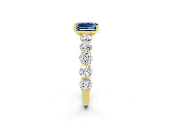 Yellow gold Emerald Cut Aquamarine Prong Setting with Side Stones on a Pave Band