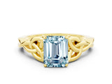 Yellow gold Emerald Cut Aquamarine Solitaire Engagement Ring with Celtic Knot Band and Four-Prong Setting