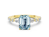 Yellow gold Emerald Cut Aquamarine Solitaire with Side Stones on a Pavé Band and Four-Prong Setting
