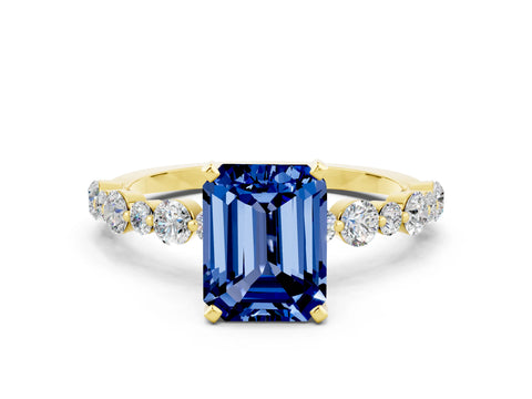 Yellow gold Emerald Cut Blue Sapphire Prong Set Engagement Ring with Pavé Band