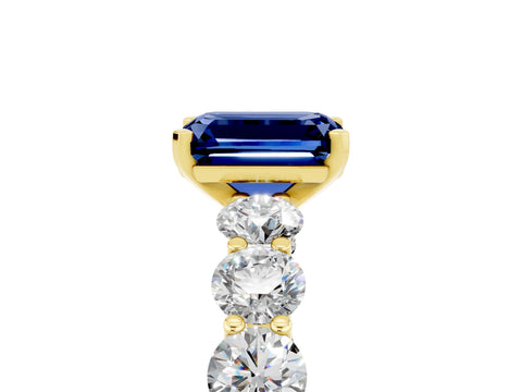 Yellow gold Emerald Cut Blue Sapphire Prong Setting with Side Stones on a Pave Band_5