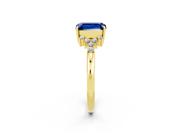 Yellow gold Emerald Cut Blue Sapphire Ring with Side Stones and Four-Prong Setting