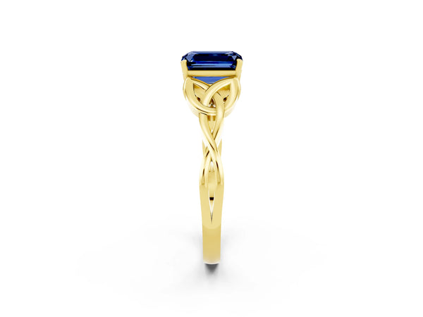 Yellow gold Emerald Cut Blue Sapphire Solitaire Celtic Knot Ring with Four-Prong Setting