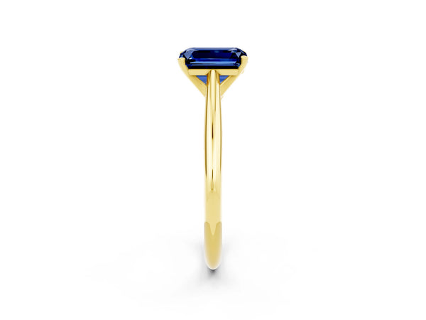 Yellow gold Emerald Cut Blue Sapphire Solitaire Engagement Ring with Cathedral Setting and Four-Prong Mount