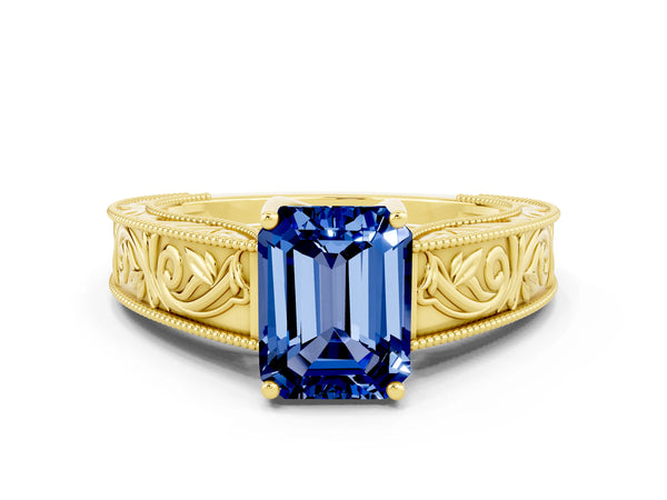 Yellow gold Emerald Cut Blue Sapphire Solitaire Ring with Engraved Band and Four-Prong Setting